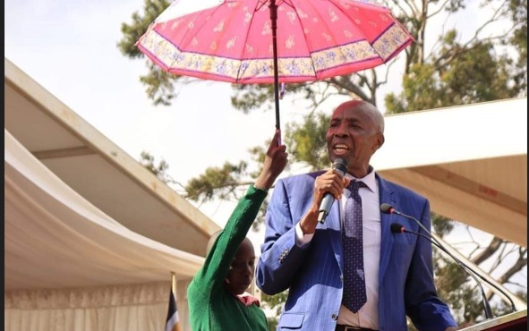 File image of a young leaner holding an umbrella for CS Ezekiel Machogu.